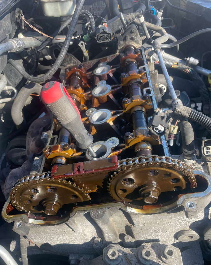 Timing chain and camshaft gears exposed during an engine service